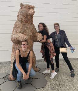 Three people posing with bear statue in Burgos