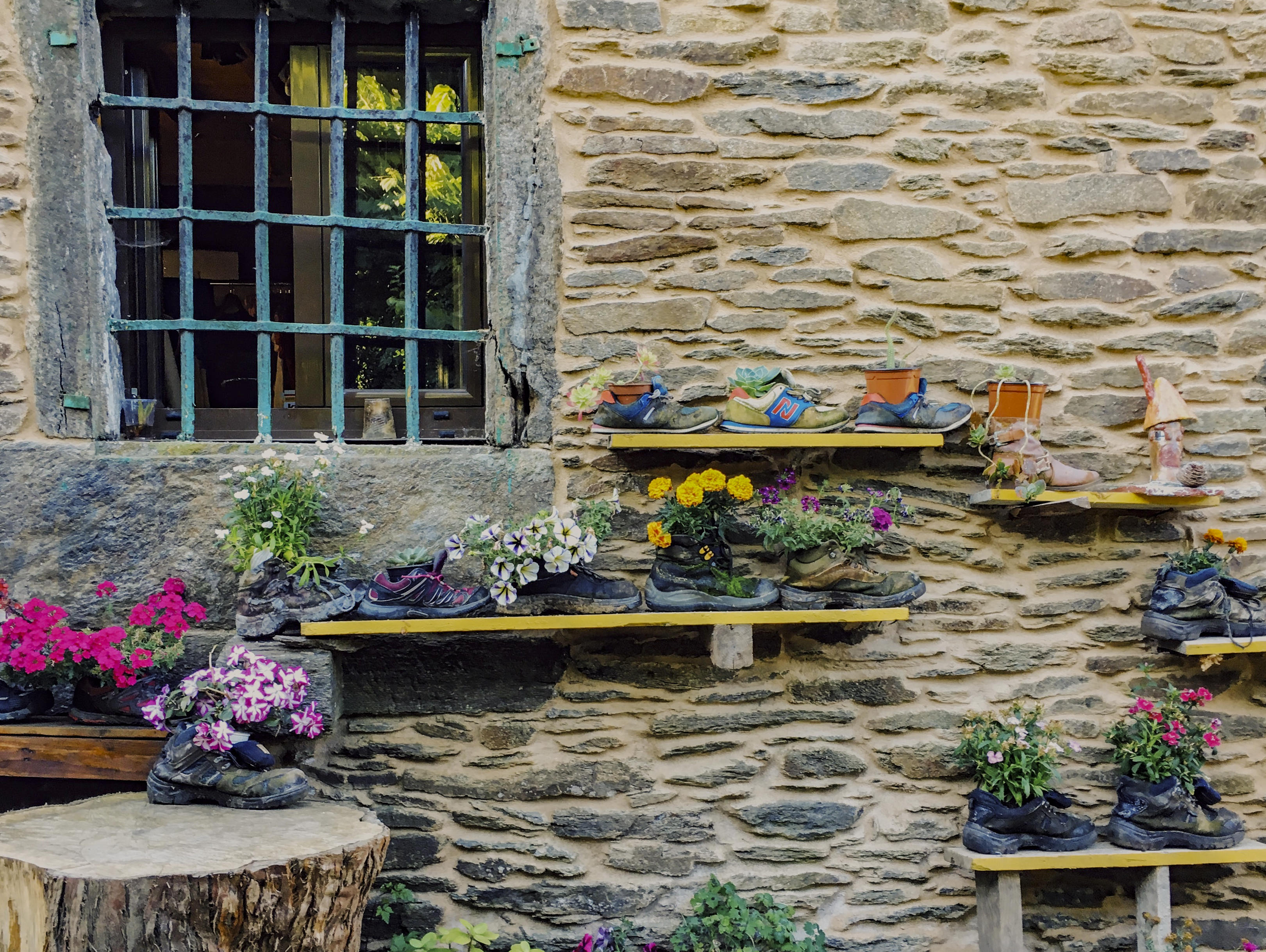 Rock wall with shoe flower planters